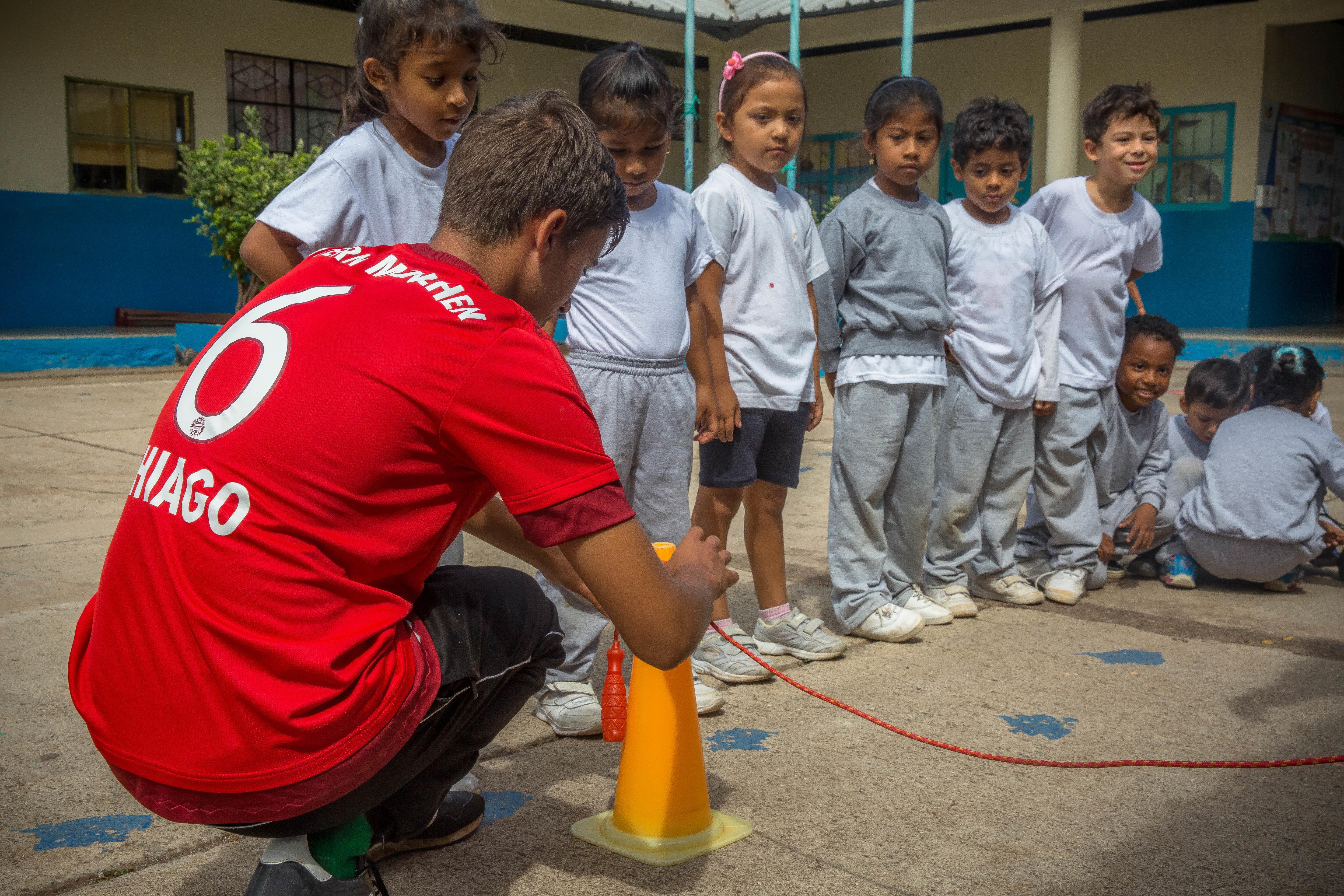An instructor sets up a fun activity while volunteering as a sports coach in Ecuador A Projects Abroad volunteer coaching sports in Ecuador helps out with a sports day
